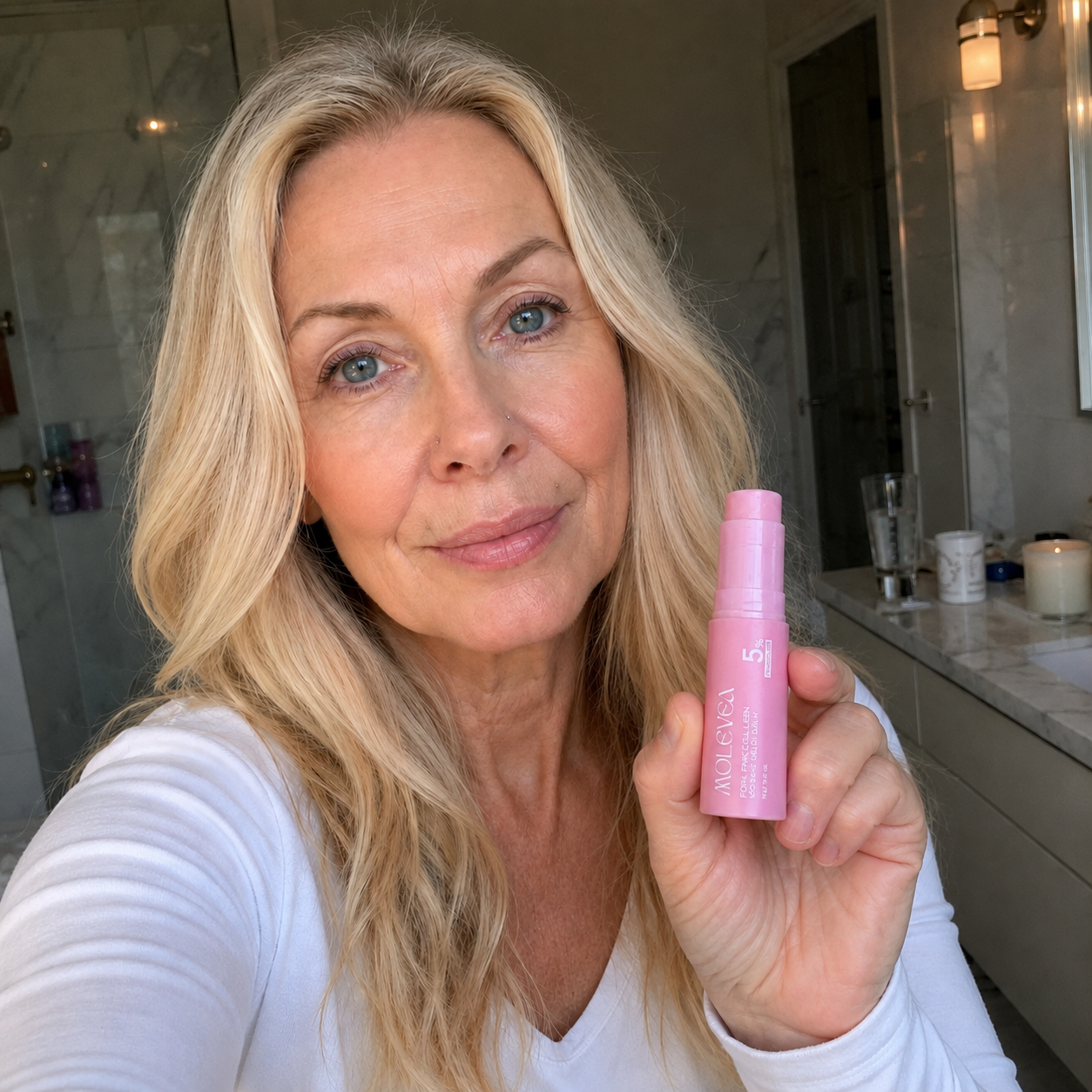 Woman holding REFLATE balm stick